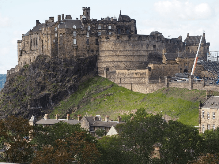 a castle on top of a stone building with Edinburgh Castle in the background